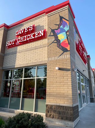 The outside location of Dave's Hot Chicken is a brick building with colorful splashes of color on Burnside in Gresham.
