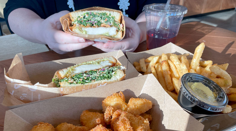 A woman's hands hold a chicken sandwich or "sando" at Tanaka restaurnt in Gresham's Civic Neighborhood.